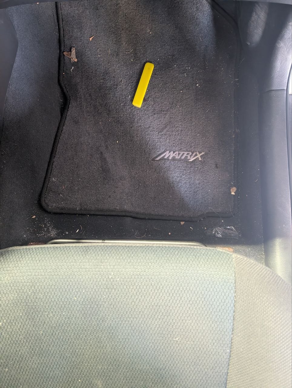 Toyota Matrix floor mat before — dirty with debris