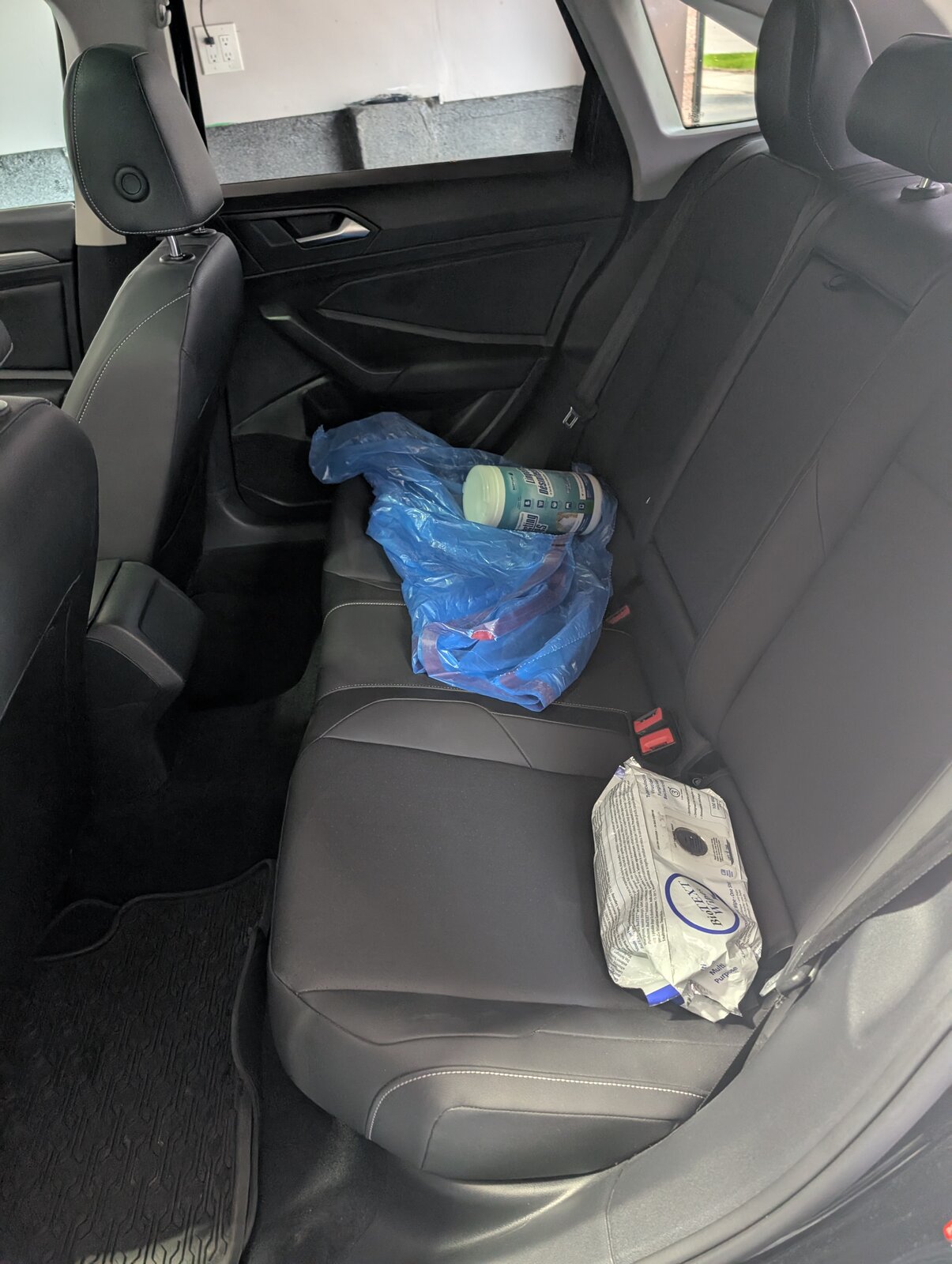 Back seat before detailing — debris and trash